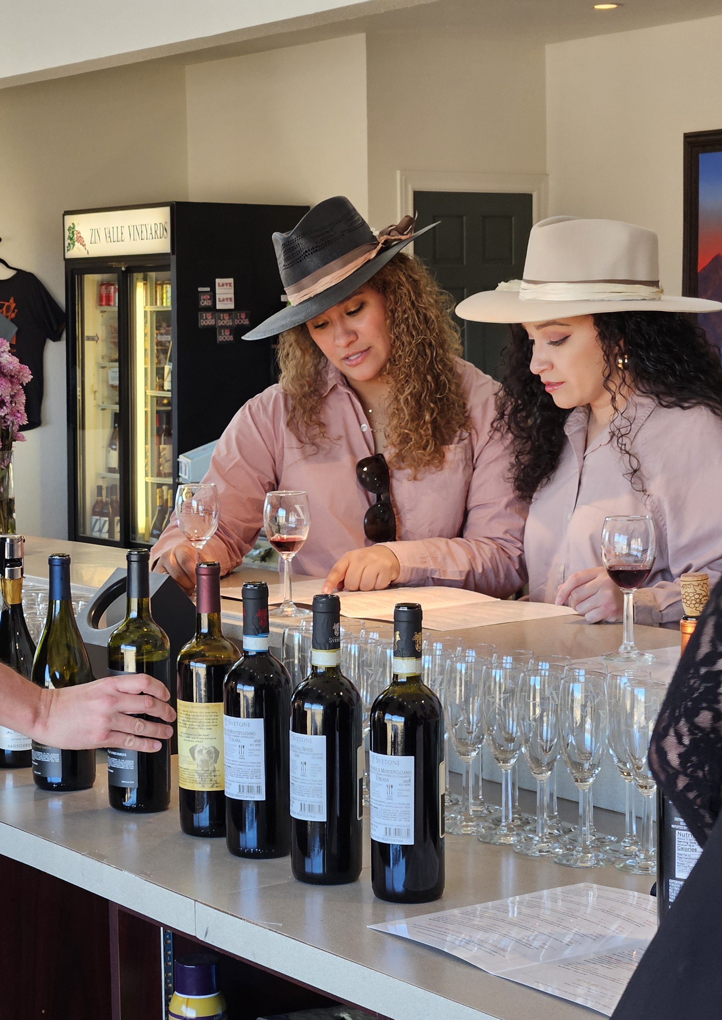 Two women select wine on a wine tour